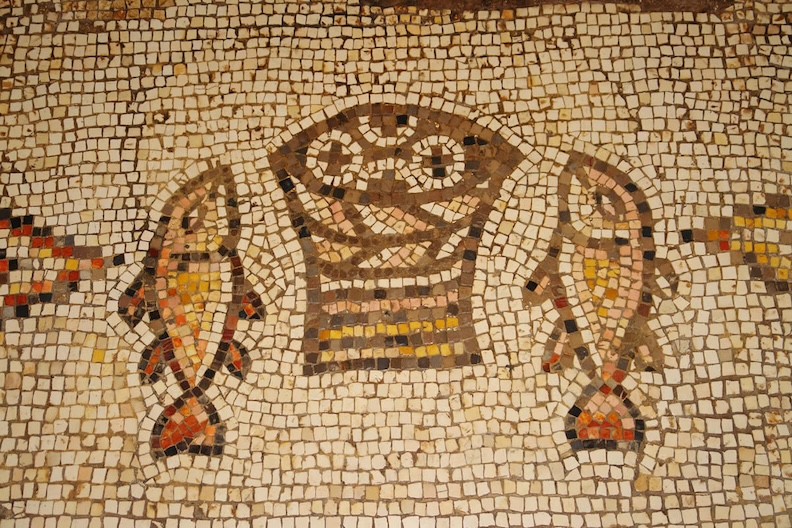 Mosaico de panes y peces como símbolo de la Eucaristía y alimento del peregrino cristiano.